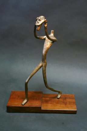 A bronze sculpture of a man holding a bat.