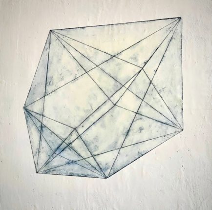 A drawing of a geometric shape on a wall.