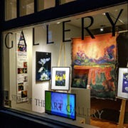 A window display of art in a store window.