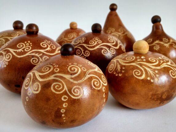 A group of wooden ornaments with designs on them.