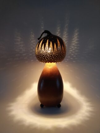 A brown lamp with a light shining on it.