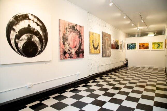 A black and white checkered floor in an art gallery.