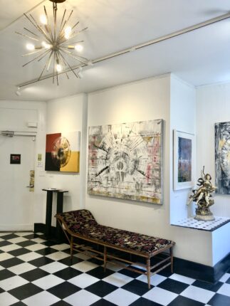 An art gallery with a black and white checkered floor.