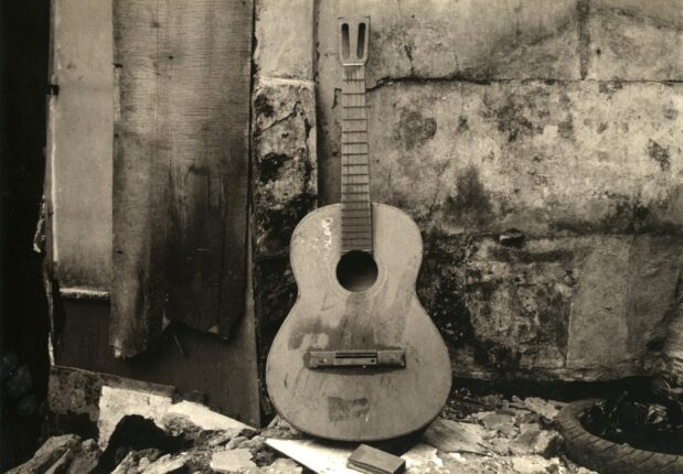 An old black and white photograph of a guitar.