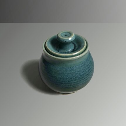 A small blue ceramic jar with a lid.