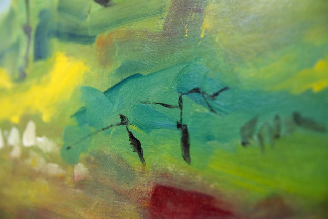 A close up of an abstract painting of a green field.