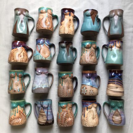 A group of mugs with different designs on them.