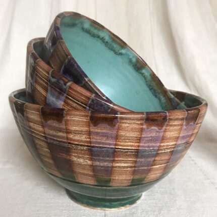 Three bowls with a green, blue and brown pattern.