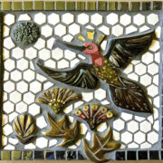 A mosaic tile with a hummingbird on it.