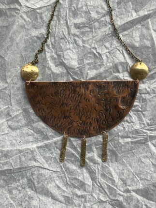 A necklace with a brown and gold design on it.