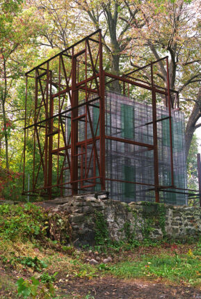 A metal structure in the middle of a forest.