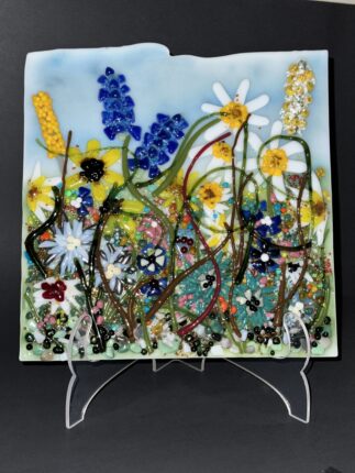 A glass painting of flowers on display.