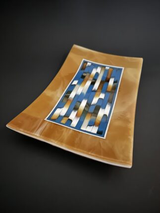 A rectangular plate with an abstract design on it.
