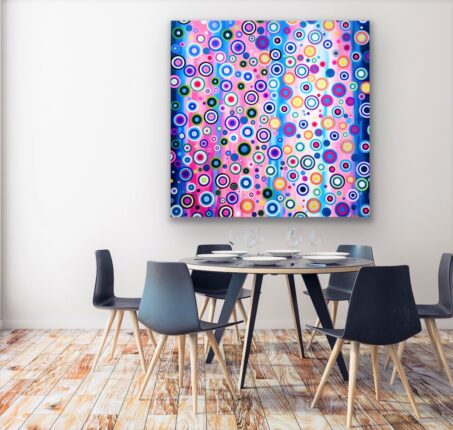 A colorful abstract painting hangs above a dining table.