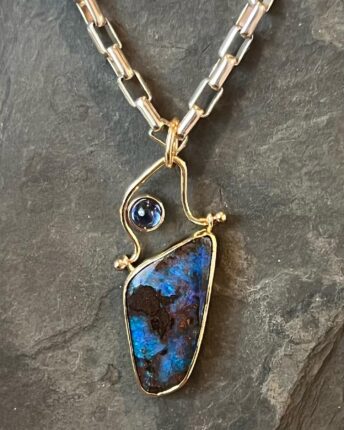 A necklace with a blue opal stone and a blue sapphire.
