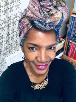 A woman with a head wrap on her head.
