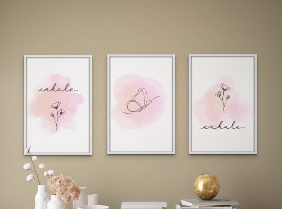 Three framed prints of scissors and a flower.