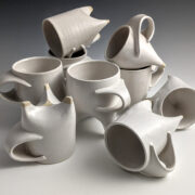 A group of white ceramic mugs arranged in a circle.
